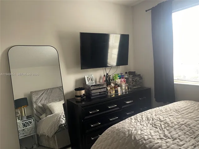 a living room with furniture and a lamp