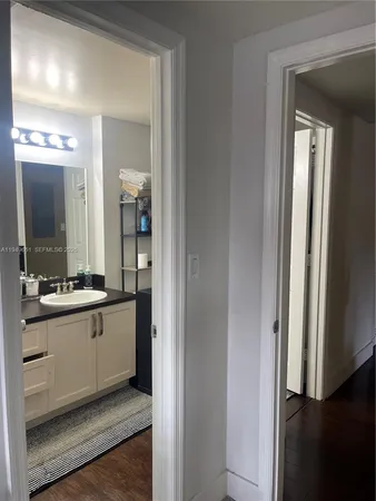 a bathroom with a sink vanity and a mirror