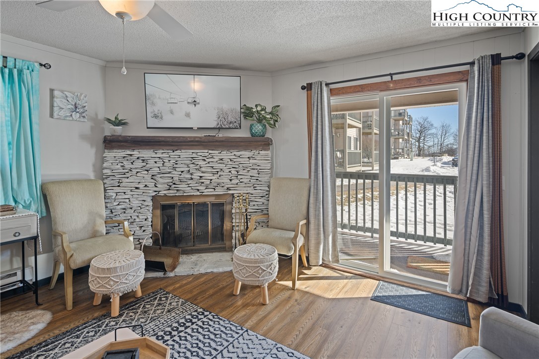 301 Pinnacle Inn Road, Unit 2101 Beech Mountain, NC 28604 - Photo 5 of 50 a living room with furniture and a fireplace