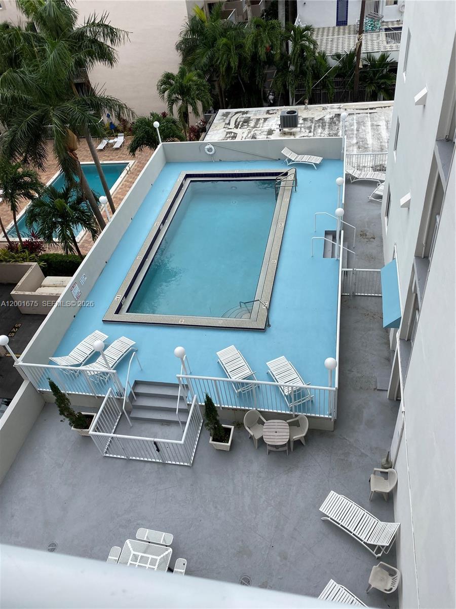 1345 Lincoln Road, Unit 704 Miami Beach, FL 33139 - Photo 14 of 17 a view of a patio with table and chairs