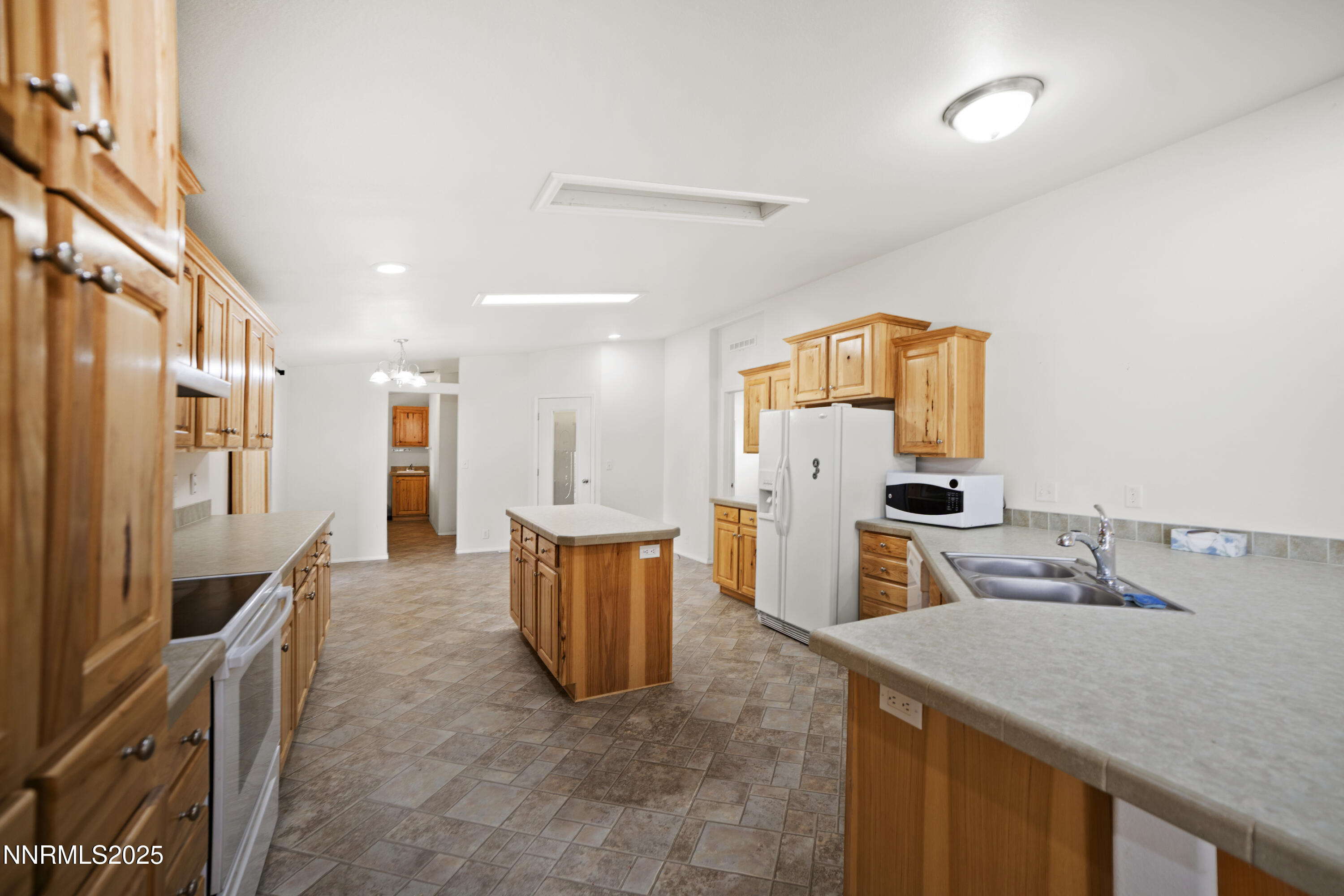 3900 Van Diest Road Winnemucca, NV 89445 - Photo 12 of 45 a kitchen that has a sink and a refrigerator