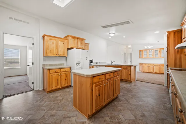 a kitchen with stainless steel appliances a sink stove and cabinets