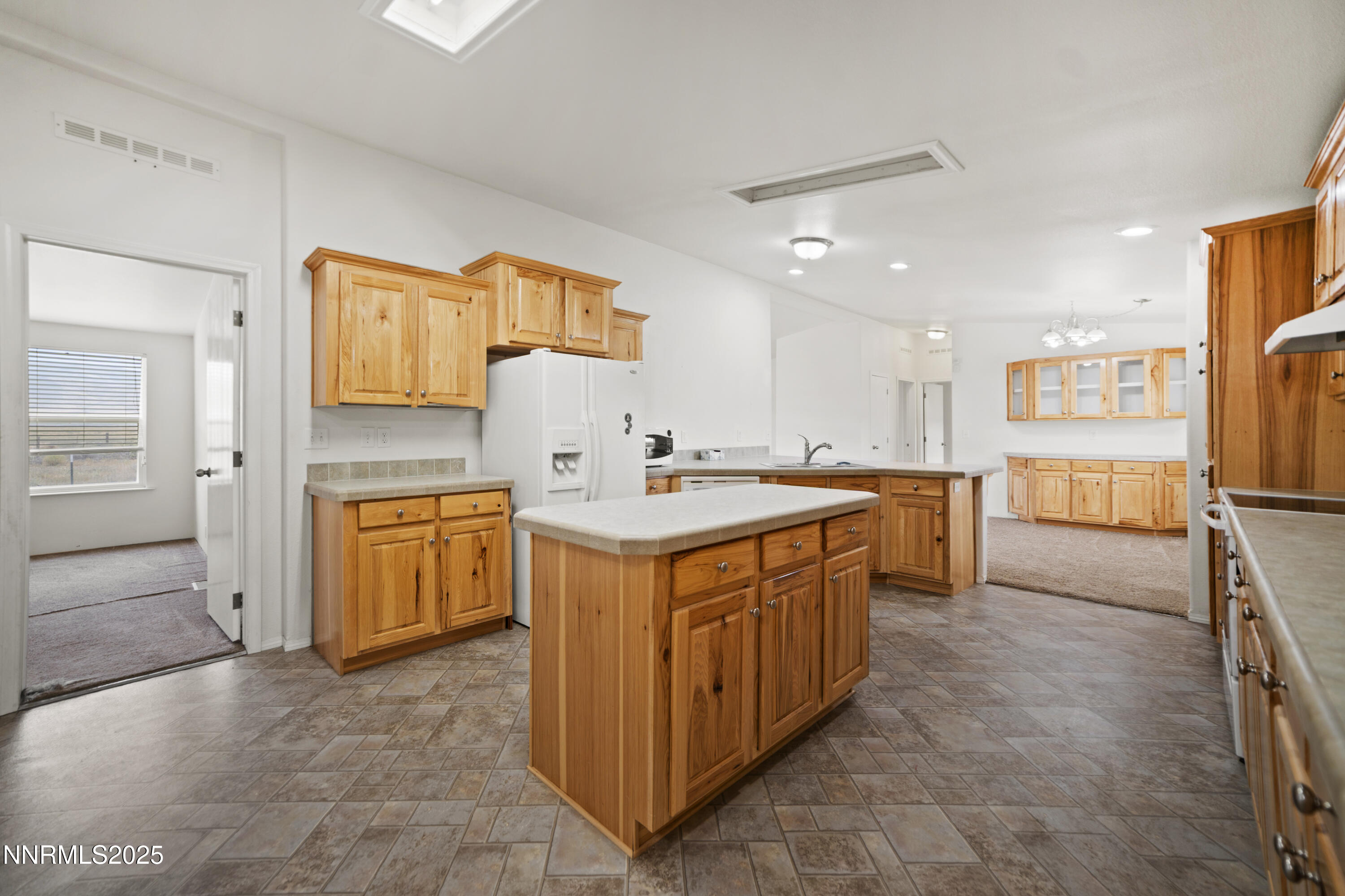 3900 Van Diest Road Winnemucca, NV 89445 - Photo 14 of 45 a kitchen with stainless steel appliances a sink stove and cabinets