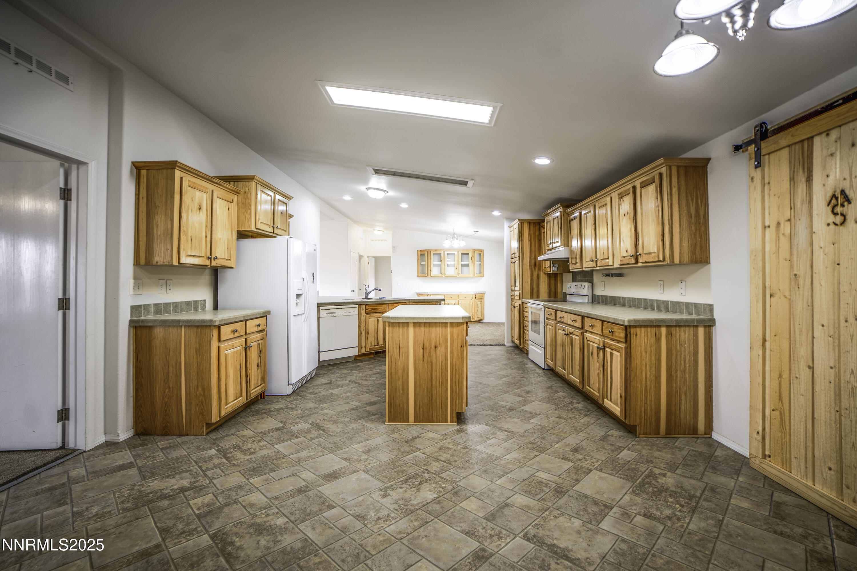 3900 Van Diest Road Winnemucca, NV 89445 - Photo 15 of 45 a kitchen with stainless steel appliances granite countertop a refrigerator and a sink