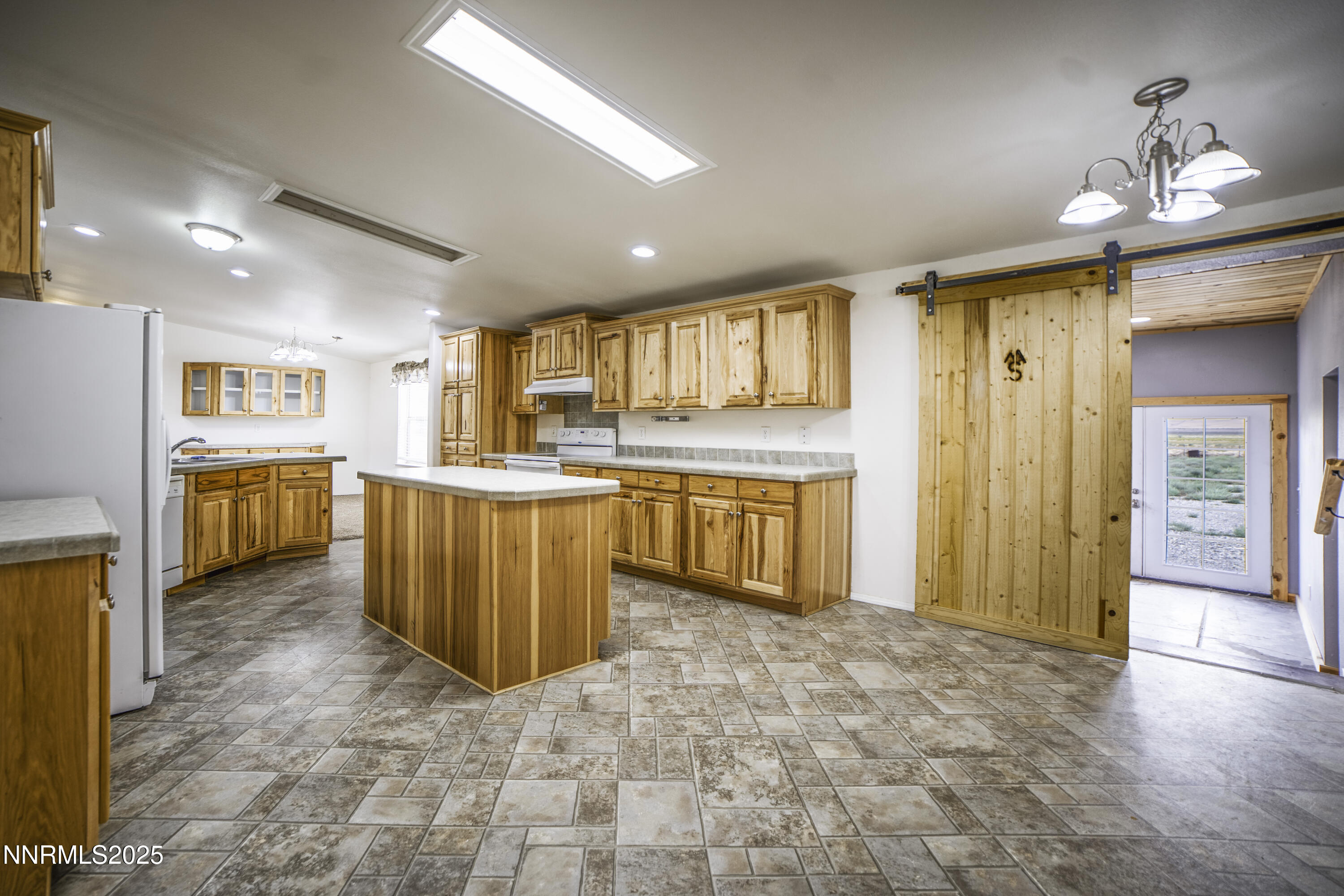 3900 Van Diest Road Winnemucca, NV 89445 - Photo 16 of 45 a kitchen with stainless steel appliances granite countertop a refrigerator and a sink