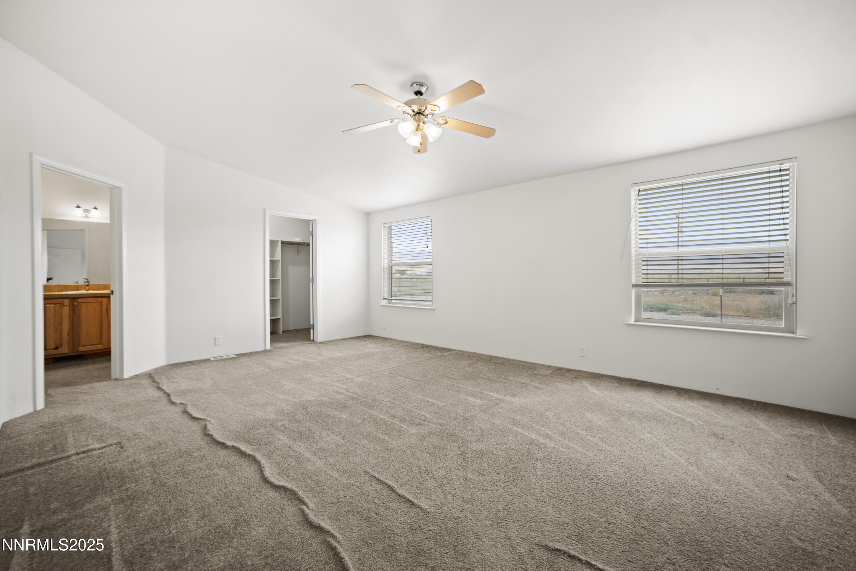 3900 Van Diest Road Winnemucca, NV 89445 - Photo 22 of 45 a view of an empty room with chandelier fan and fire place