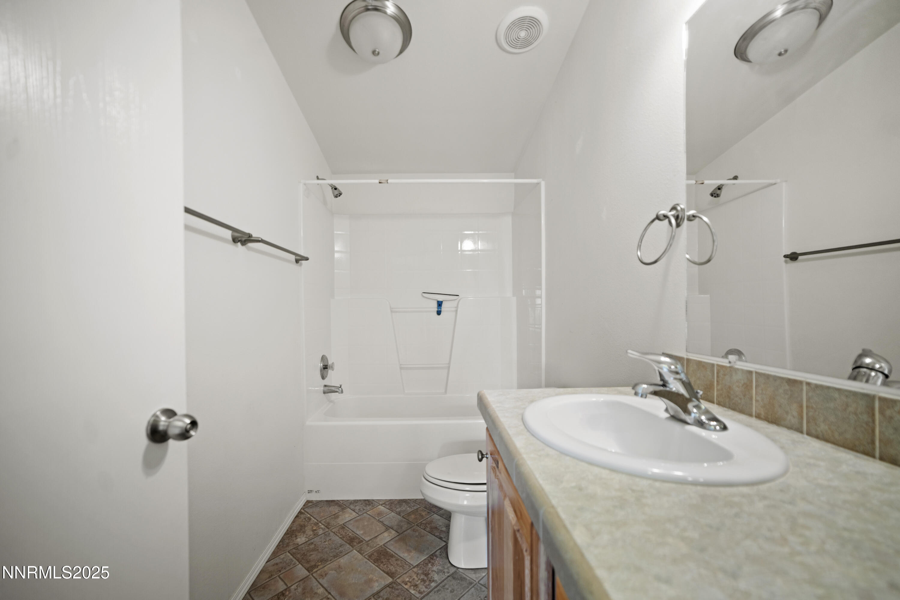 3900 Van Diest Road Winnemucca, NV 89445 - Photo 33 of 45 a bathroom with a sink toilet vanity and shower