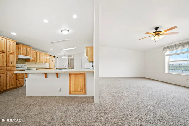 a view of kitchen with furniture and appliances