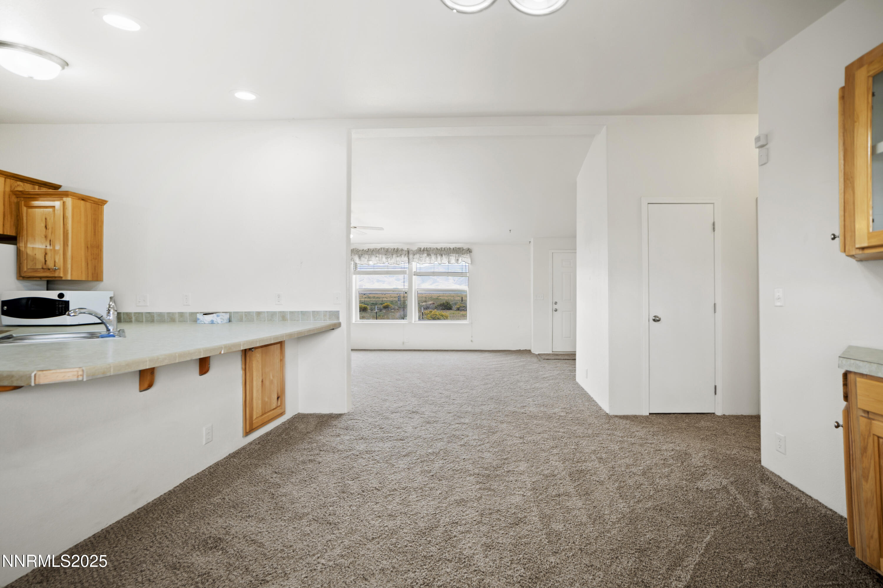 3900 Van Diest Road Winnemucca, NV 89445 - Photo 9 of 45 a view of an empty room with window and wooden floor
