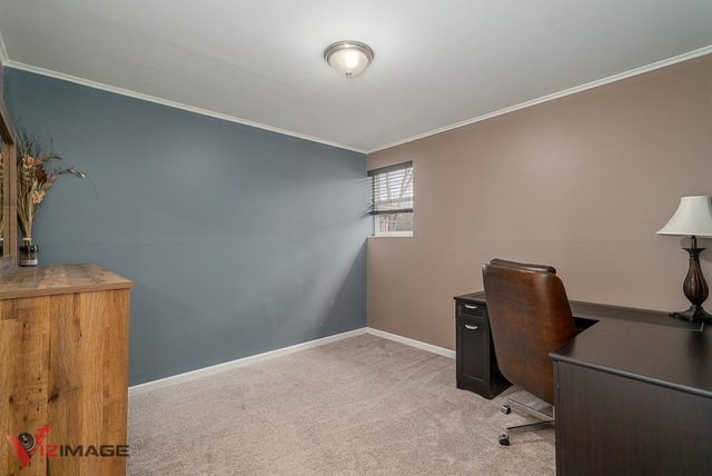 17643 Dundee Avenue Homewood, IL 60430 - Photo 11 of 27 a bedroom with a bed and a chair