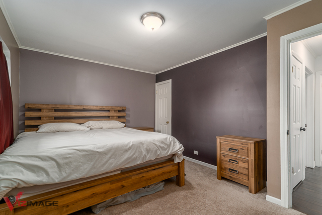 17643 Dundee Avenue Homewood, IL 60430 - Photo 12 of 27 a bedroom with a bed and a cabinets