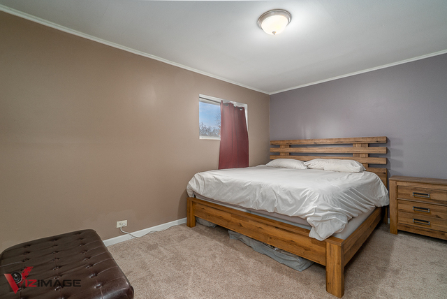 17643 Dundee Avenue Homewood, IL 60430 - Photo 13 of 27 a bed sitting in a bedroom next to a window