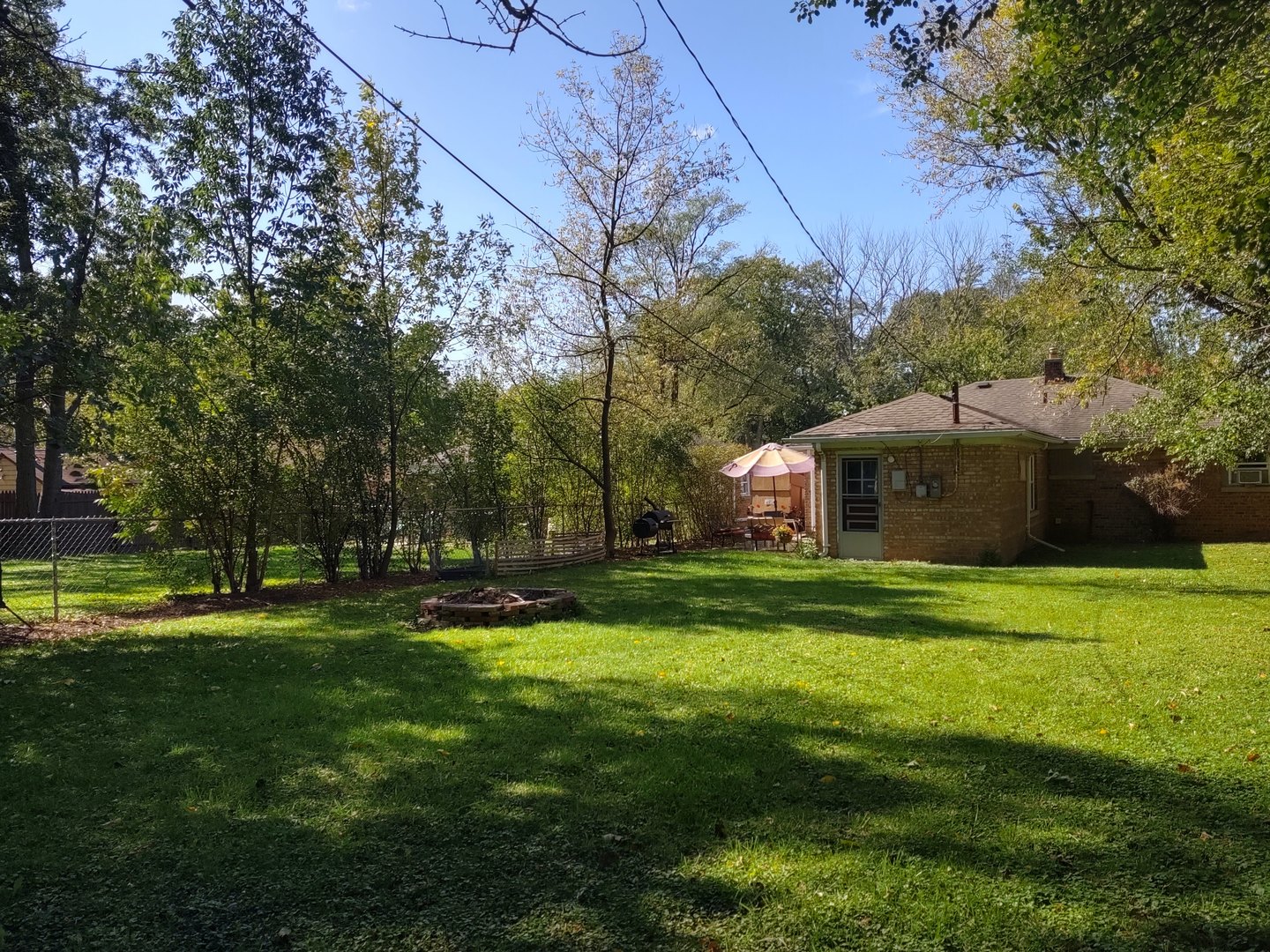 17643 Dundee Avenue Homewood, IL 60430 - Photo 25 of 27 a front view of a house with a yard and trees
