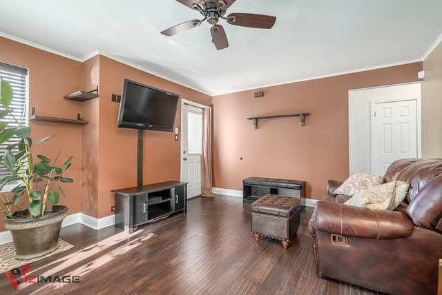 17643 Dundee Avenue Homewood, IL 60430 - Photo 5 of 27 a living room with furniture and a flat screen tv