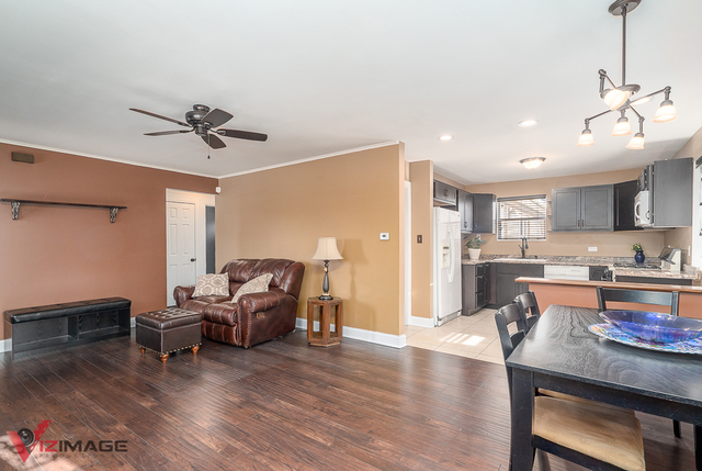 17643 Dundee Avenue Homewood, IL 60430 - Photo 6 of 27 a living room with stainless steel appliances kitchen island granite countertop furniture and a dining table