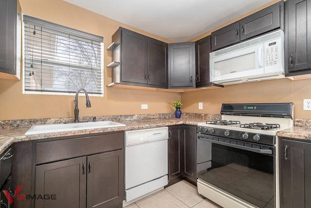 17643 Dundee Avenue Homewood, IL 60430 - Photo 8 of 27 a kitchen with cabinets appliances and a window