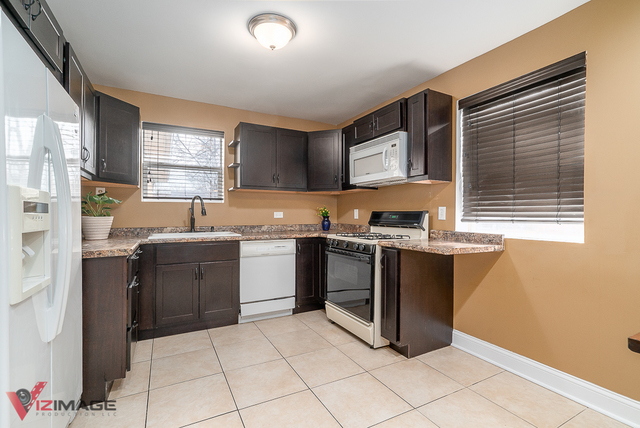 17643 Dundee Avenue Homewood, IL 60430 - Photo 9 of 27 a kitchen with granite countertop a sink cabinets and stainless steel appliances