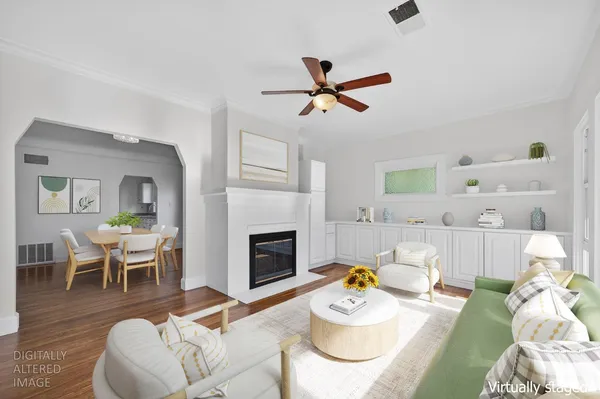 a living room with furniture a fireplace and a table