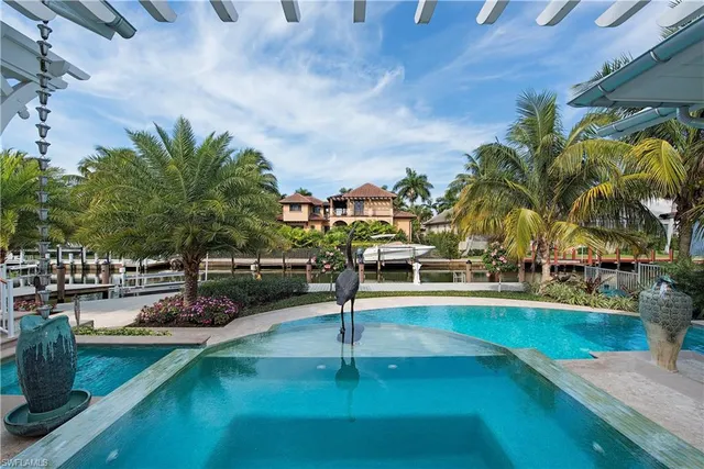 a swimming pool with outdoor seating and yard