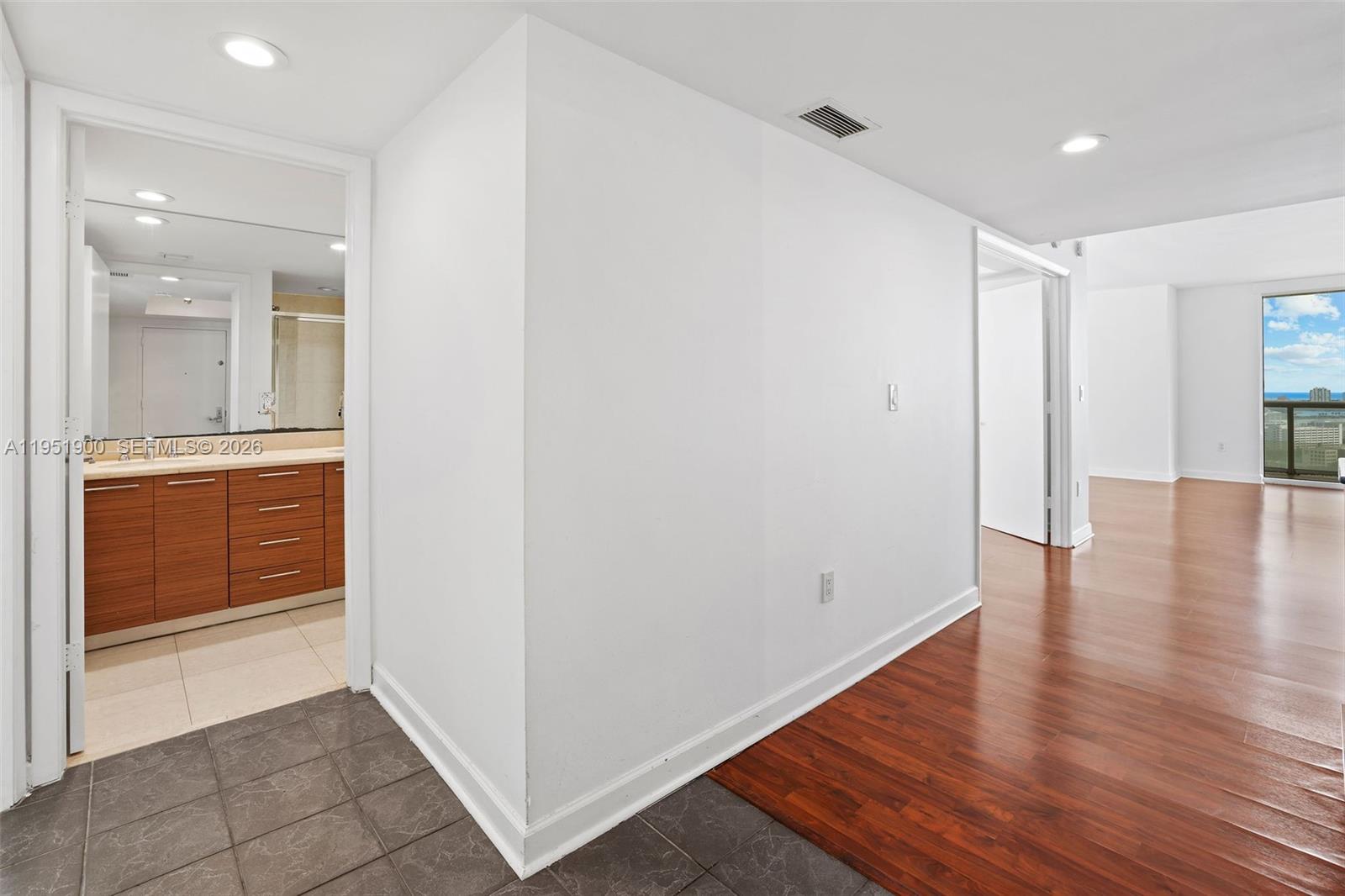 50 Biscayne Boulevard, Unit 3102 Miami, FL 33132 - Photo 23 of 36 a view of an empty room with wooden floor and a bathroom