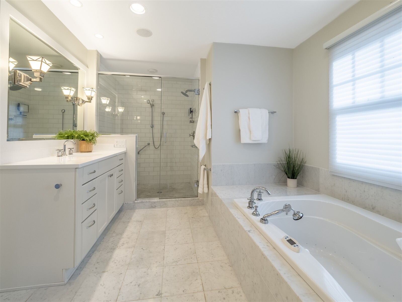 30 Wild Duck Road Wilton, CT 06897 - Photo 21 of 40 a bathroom with a bathtub a double vanity sink a vanity a window and a shower