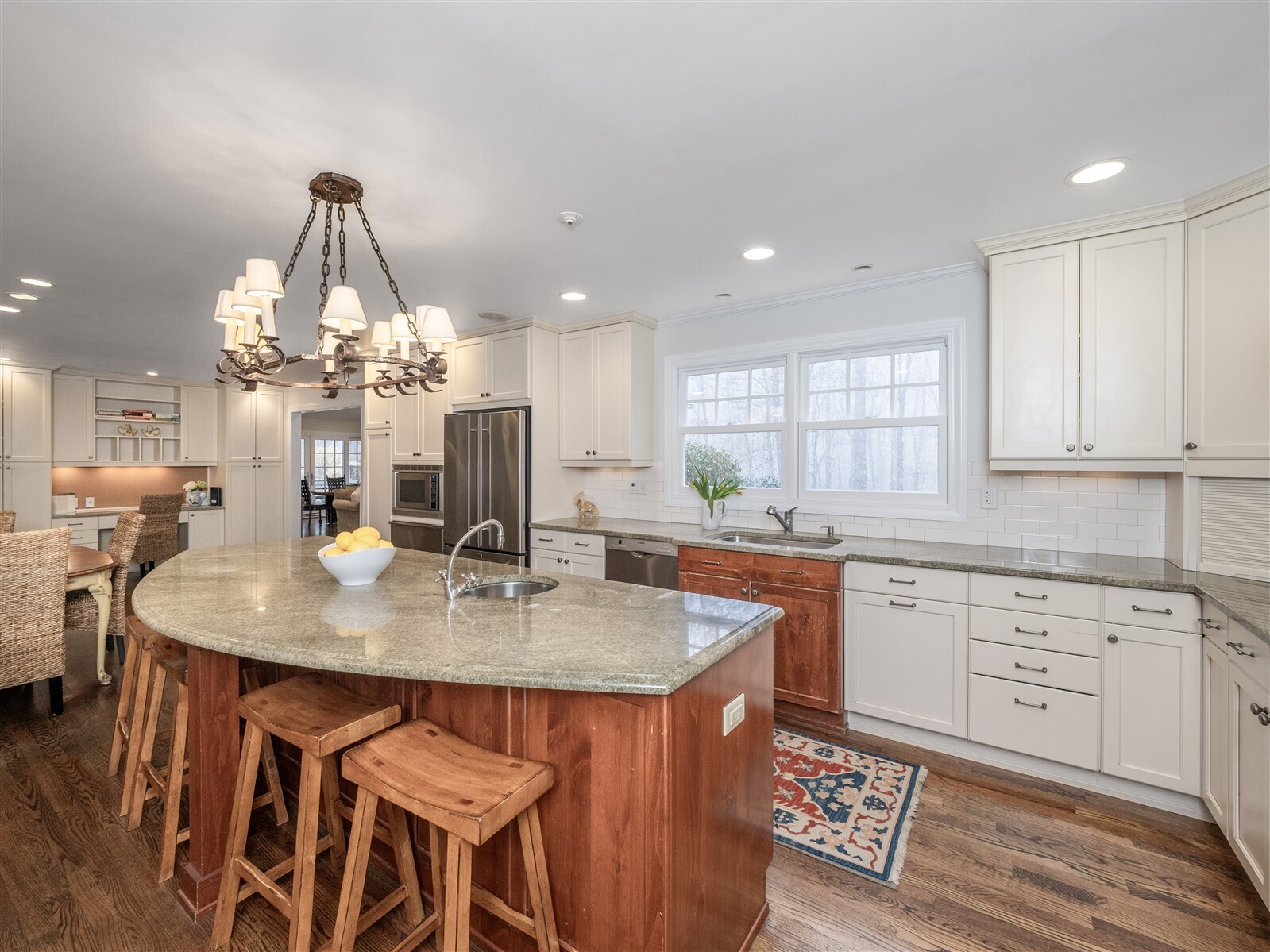 30 Wild Duck Road Wilton, CT 06897 - Photo 5 of 40 a kitchen with stainless steel appliances a table chairs and chandelier