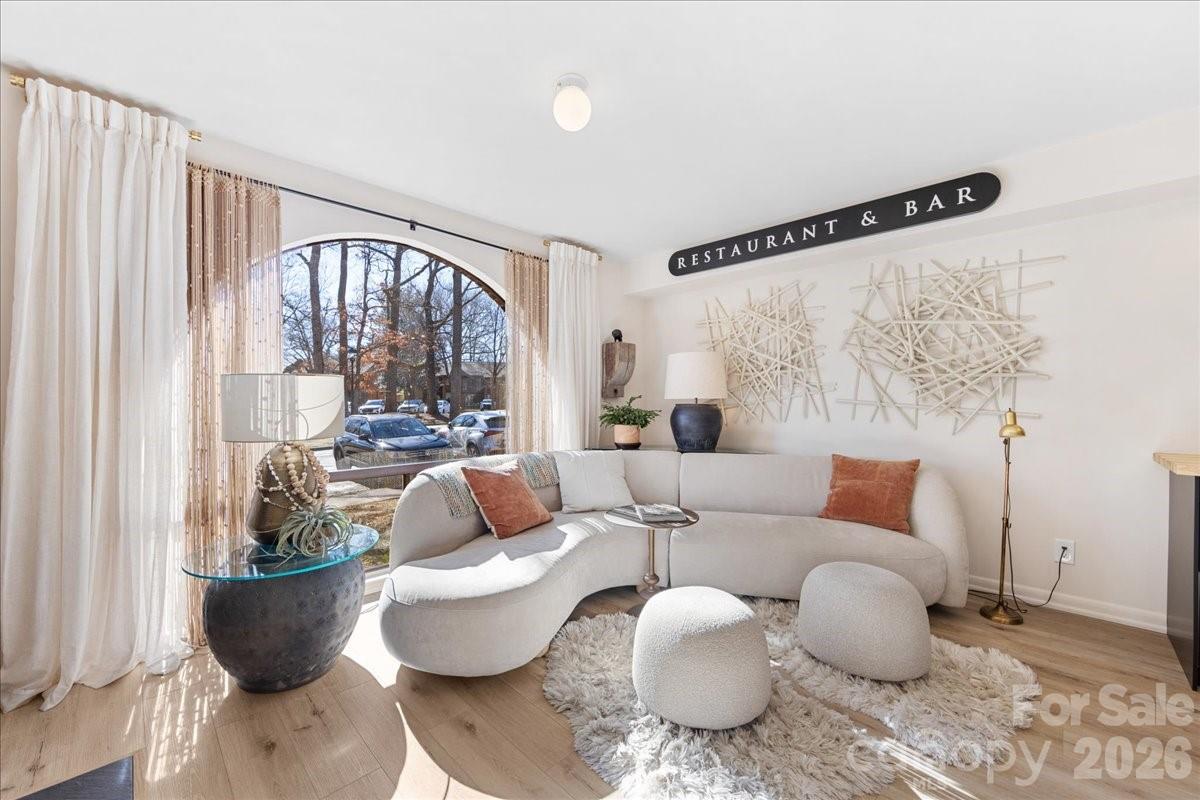 5801 Sharon Road, Unit J Charlotte, NC 28210 - Photo 11 of 46 a living room with furniture and a large window