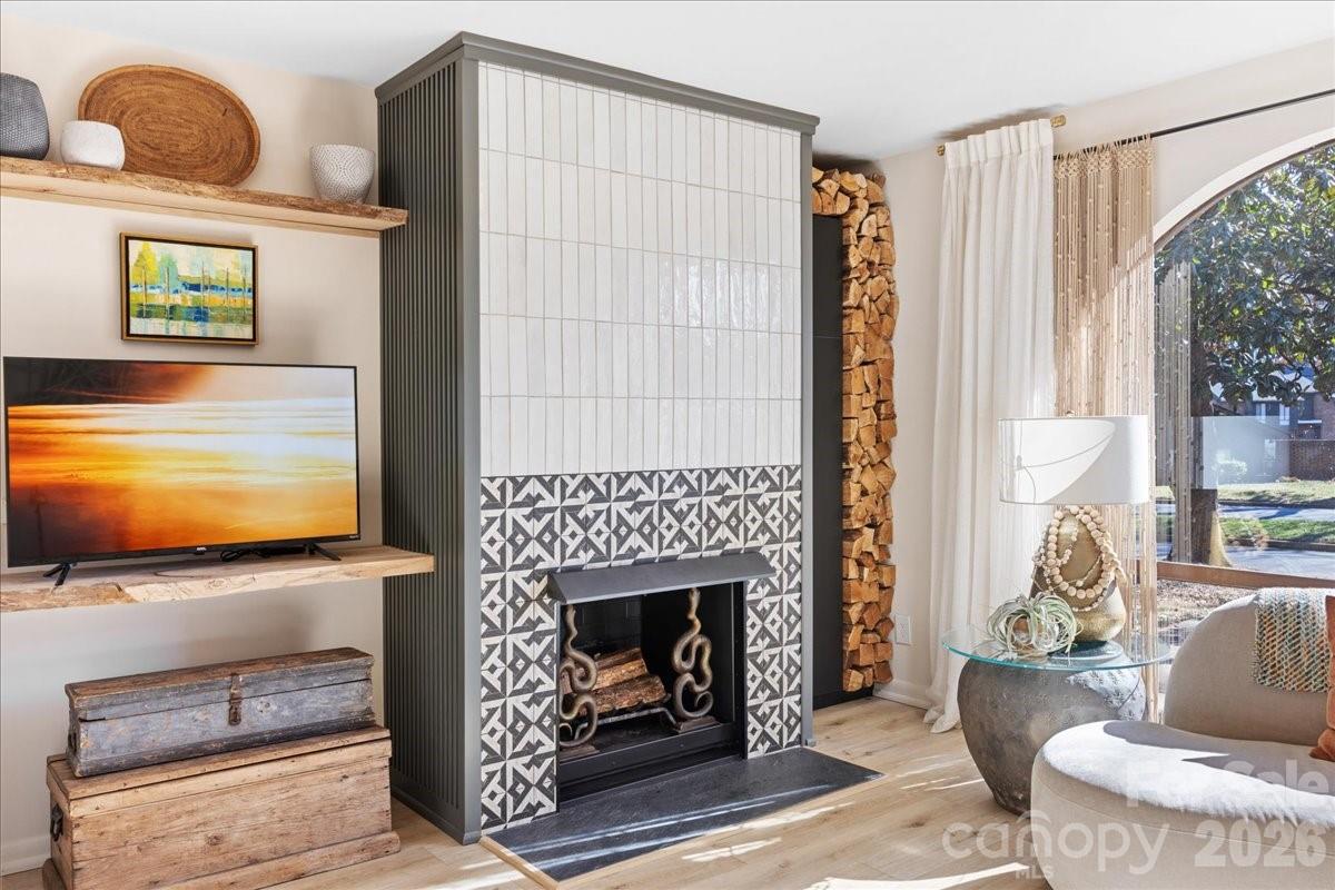 5801 Sharon Road, Unit J Charlotte, NC 28210 - Photo 13 of 46 a living room with furniture a flat screen tv and a fireplace