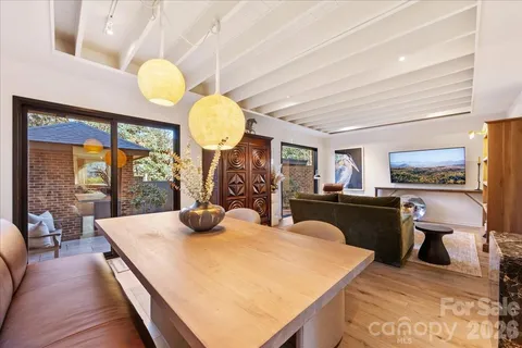 a kitchen with stainless steel appliances kitchen island granite countertop a sink a counter space and living room view