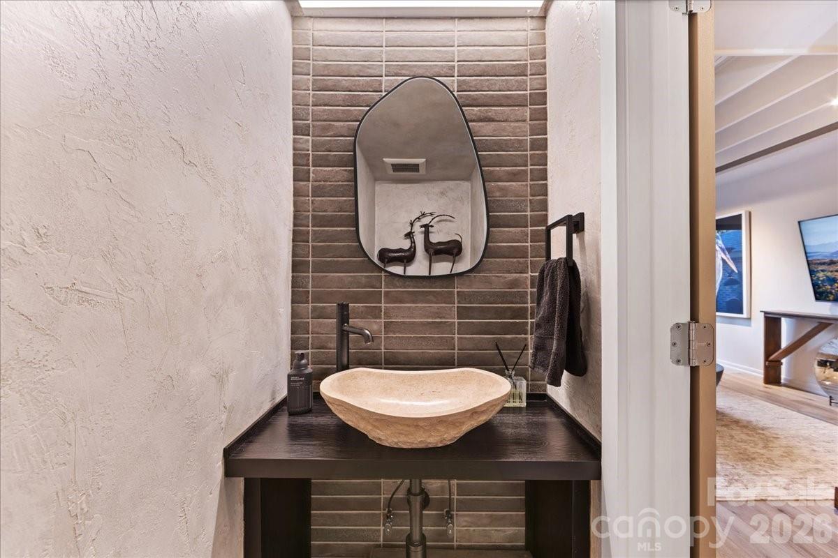 5801 Sharon Road, Unit J Charlotte, NC 28210 - Photo 22 of 46 a bathroom with a sink and a mirror