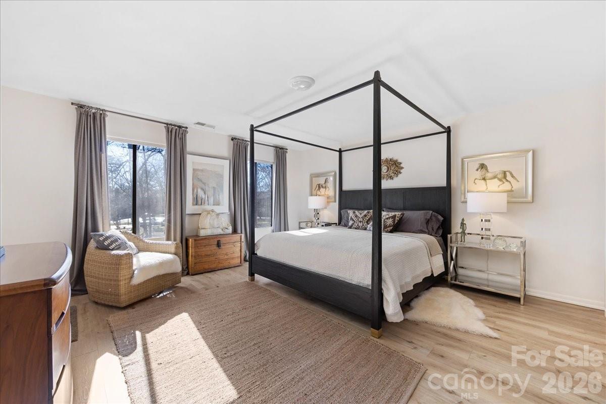 5801 Sharon Road, Unit J Charlotte, NC 28210 - Photo 24 of 46 a bedroom with a bed lamp closet and large window