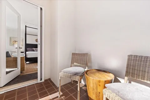 a bathroom with a granite countertop sink a toilet and a mirror