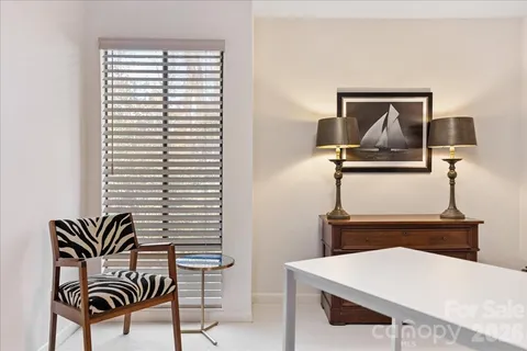 a living room with furniture a rug and a window