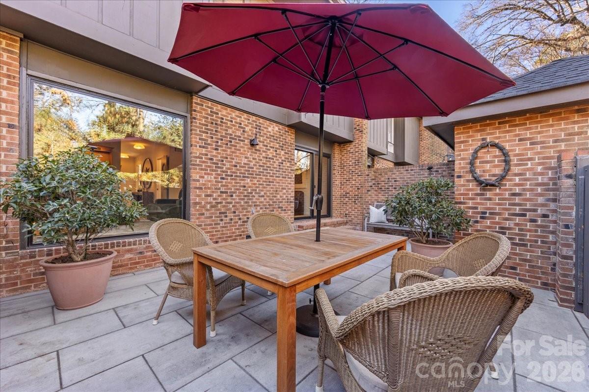 5801 Sharon Road, Unit J Charlotte, NC 28210 - Photo 40 of 46 a view of an outdoor sitting area with furniture and umbrella