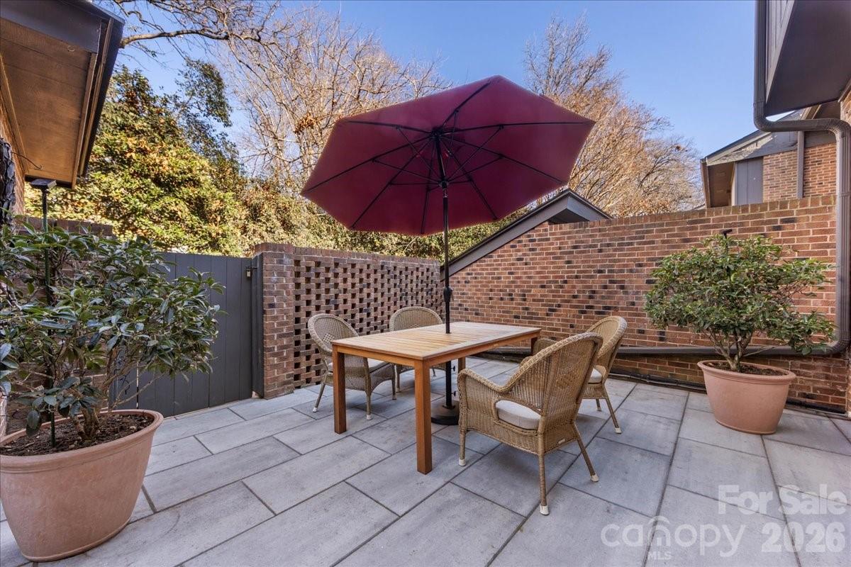 5801 Sharon Road, Unit J Charlotte, NC 28210 - Photo 43 of 46 a view of a chairs and table in backyard