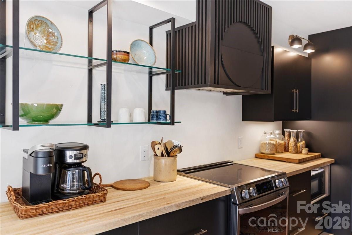 5801 Sharon Road, Unit J Charlotte, NC 28210 - Photo 6 of 46 a kitchen with a stove and a sink
