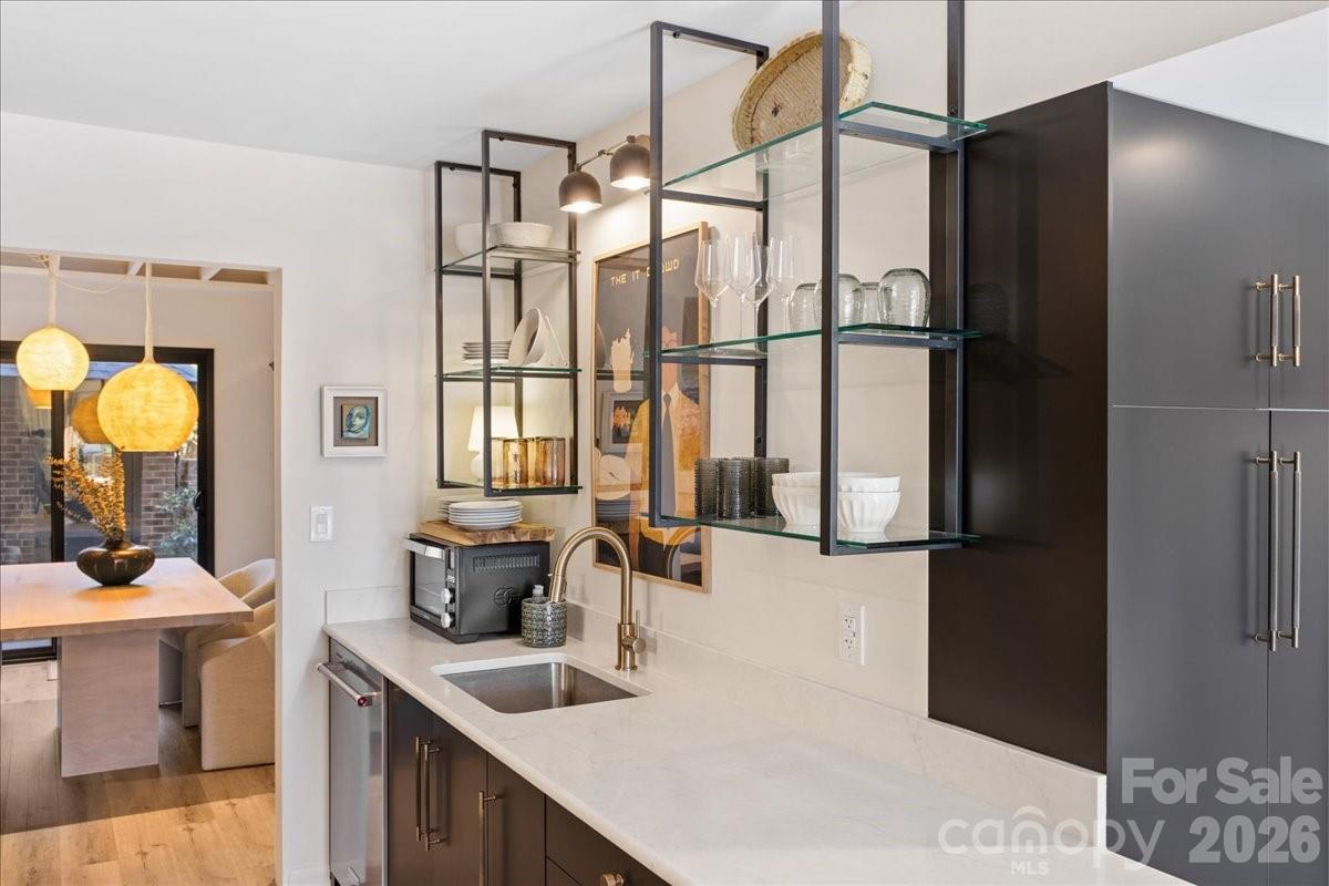 5801 Sharon Road, Unit J Charlotte, NC 28210 - Photo 8 of 46 a kitchen with a sink and a refrigerator
