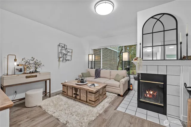 a living room with furniture a fireplace and window