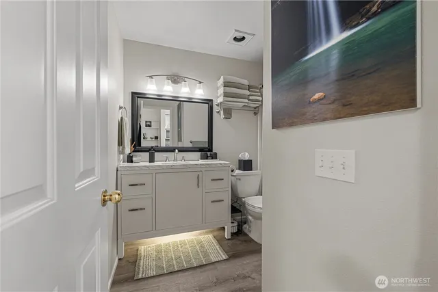a bathroom with a sink a mirror and a toilet