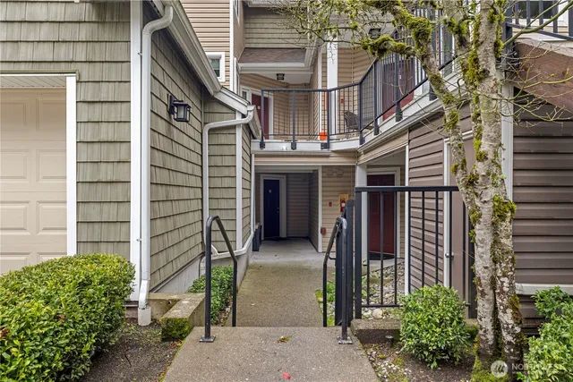 a view of a house with a small yard and plants