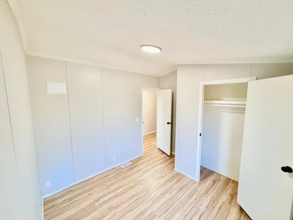 a view of a room with wooden floor and closet