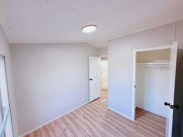 a view of a room with wooden floor