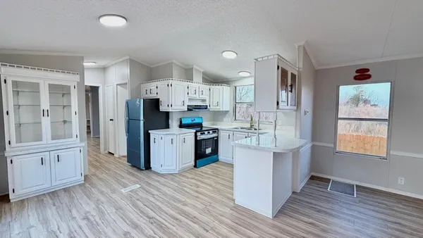 a kitchen with stainless steel appliances a refrigerator sink and cabinets