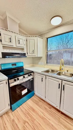 a kitchen with stainless steel appliances granite countertop a stove and a sink