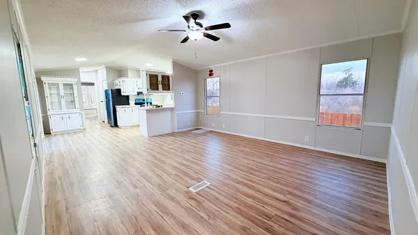 a view of a kitchen with wooden floor and a kitchen view