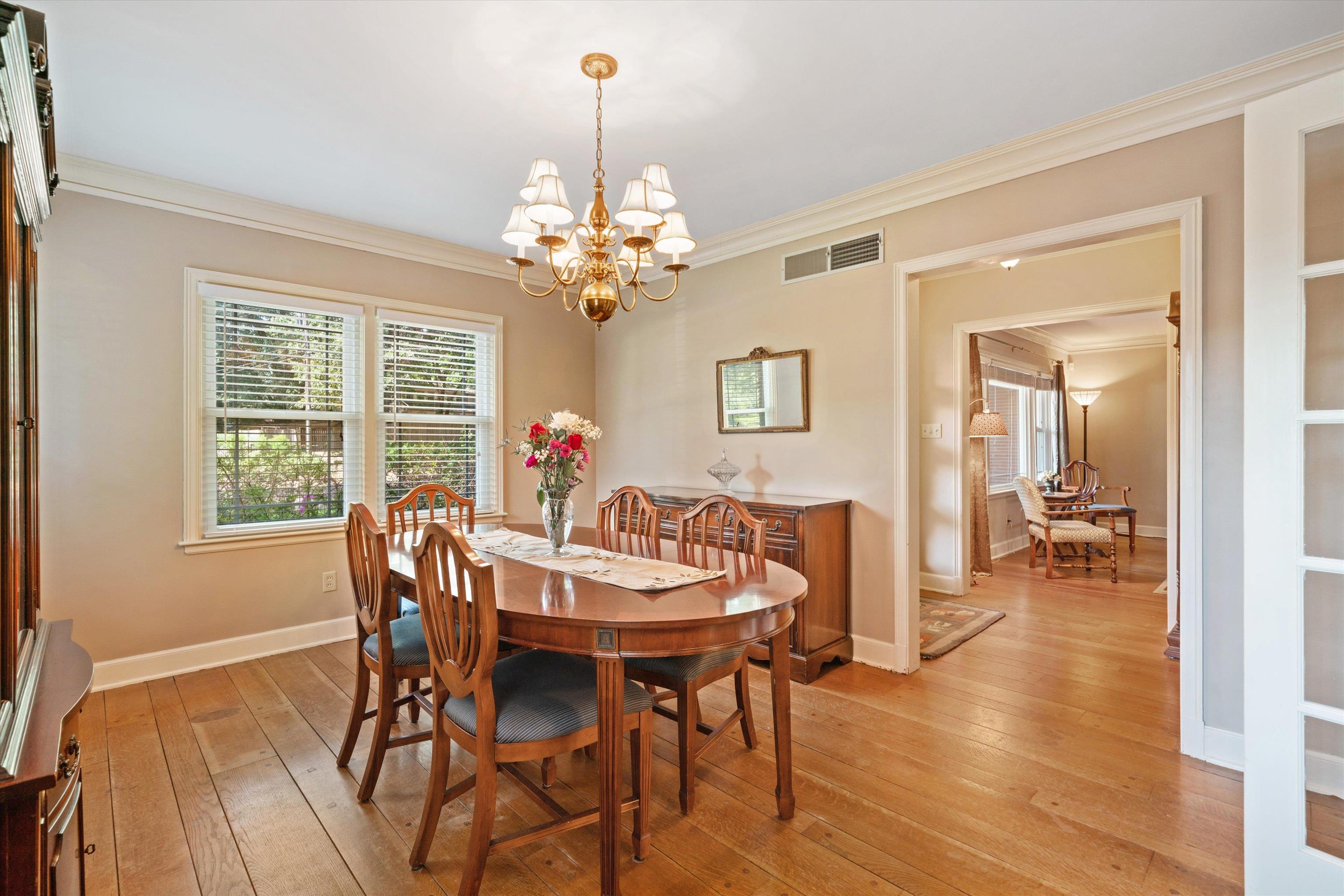 3374 Walnut Grove Road Memphis, TN 38111 - Photo 9 of 25 a view of a dining room with furniture wooden floor and chandelier