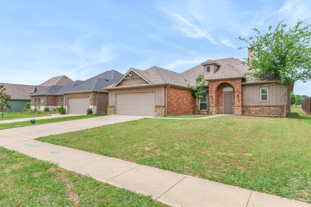 1852 Meadowview Canton, TX 75103 - Photo 28 of 28 a front view of a house with a garden and yard