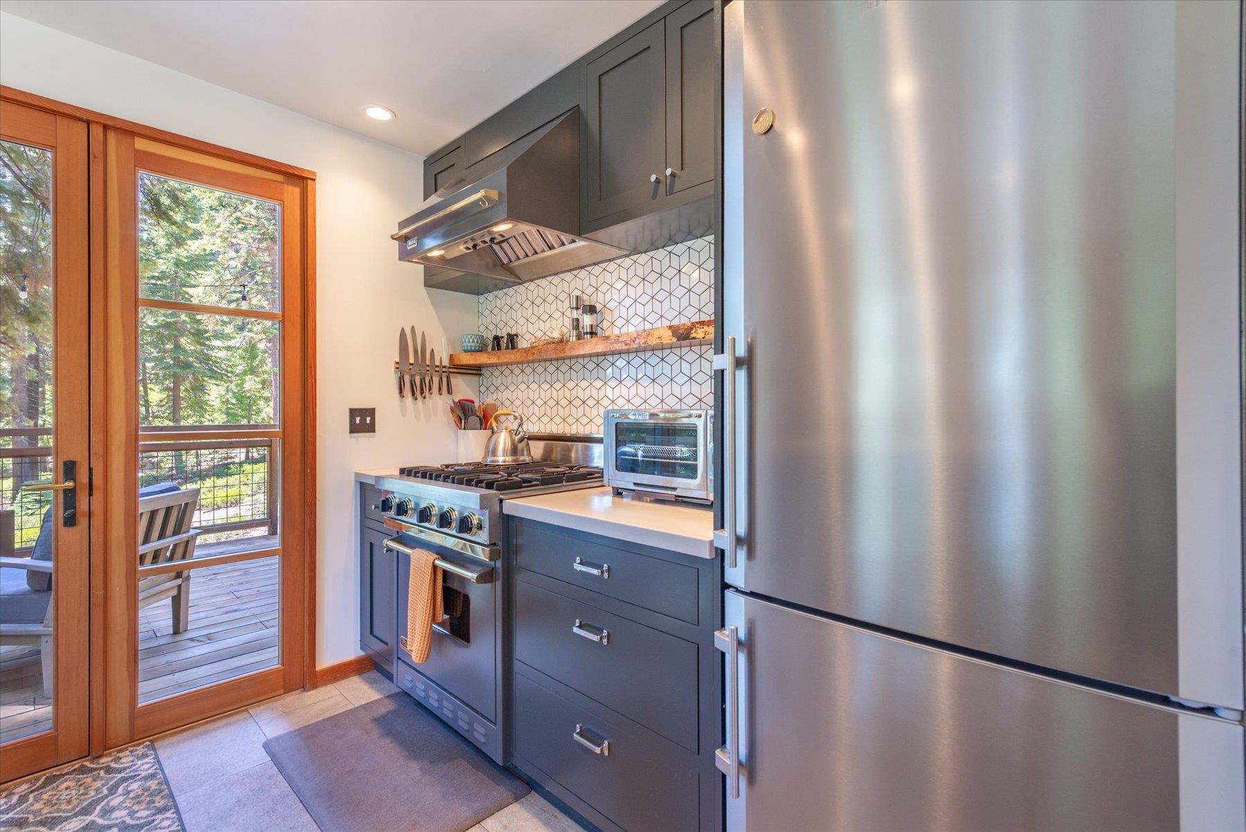 625 High Street Carnelian Bay, CA 96140 - Photo 11 of 22 a kitchen with stainless steel appliances granite countertop a refrigerator and a stove