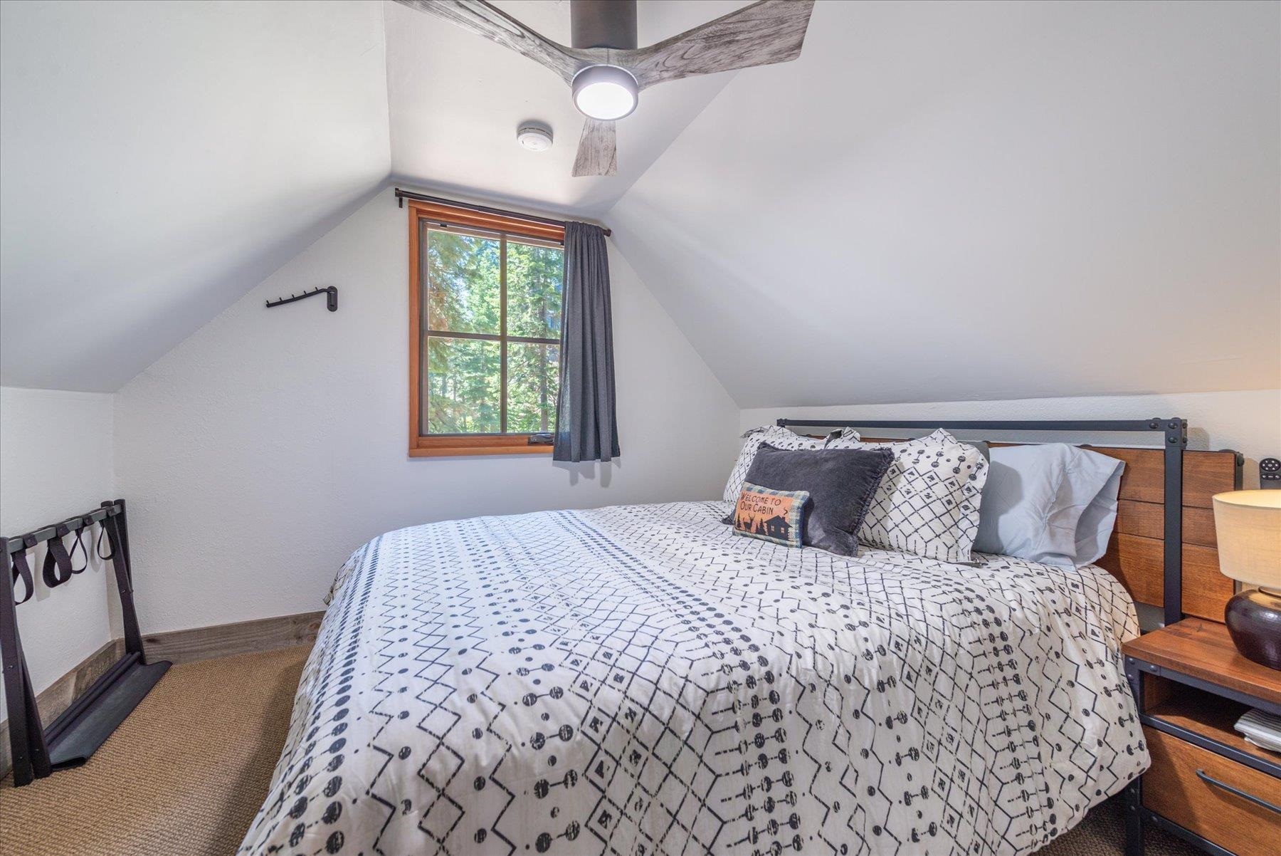 625 High Street Carnelian Bay, CA 96140 - Photo 13 of 22 a bedroom with a large bed and a window