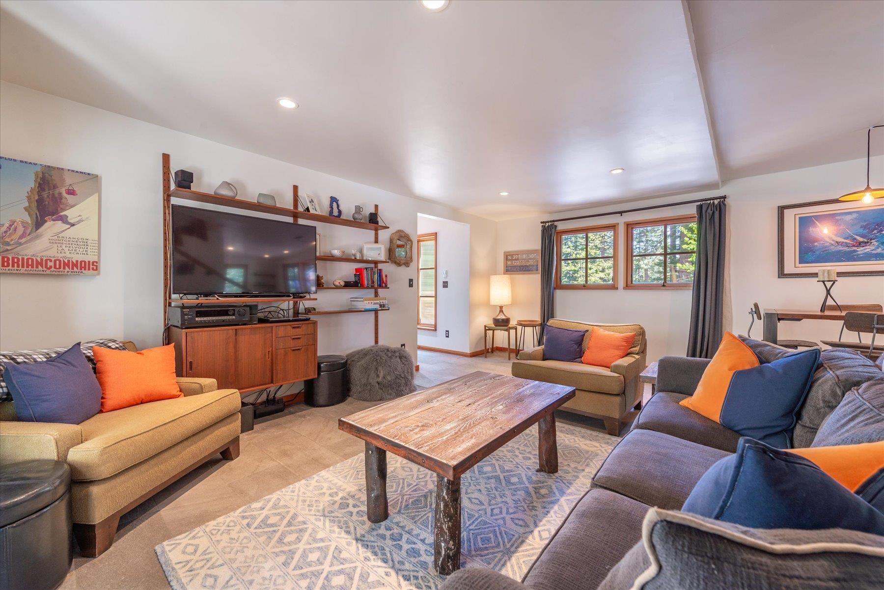 625 High Street Carnelian Bay, CA 96140 - Photo 6 of 22 a living room with furniture a flat screen tv and kitchen view